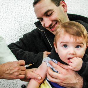 Bosnian father and child during immunization